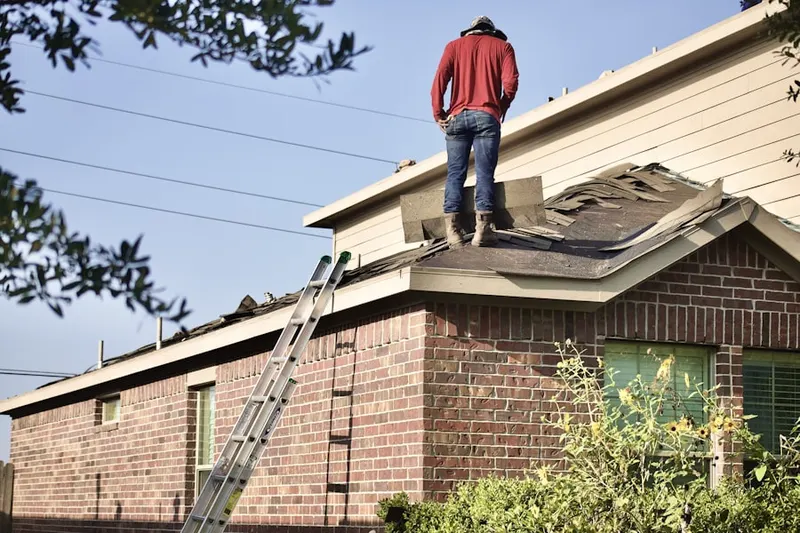 Professional roofer working on a residential roof in Fashion District
